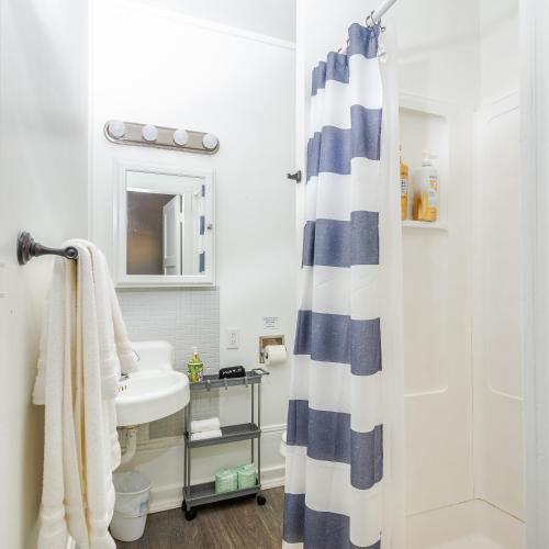 a bathroom with a shower curtain and a sink at Solvang Bungalow B in Solvang
