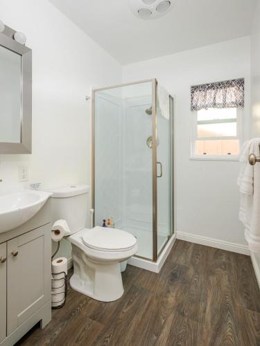 a bathroom with a toilet and a glass shower at Solvang Bungalow A in Solvang