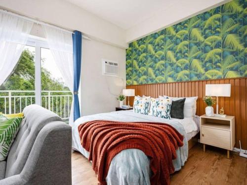 a bedroom with a large bed and a window at 309B Condotel Near Airport &Mall,Pool,Gym,Netflix in Pusok