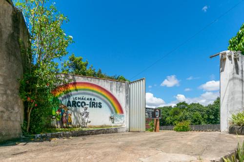 a building with a rainbow painted on it at Chácara Arco Íris in Conde