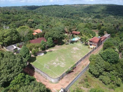 an aerial view of a house with a soccer field at Chácara Arco Íris in Conde