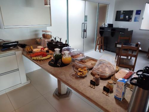 a kitchen counter with food and drinks on it at Hibisco Guest House in Florianópolis