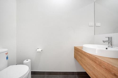 a bathroom with a sink and a toilet at Charming Cozy Stylish Unique Retreat, Steps from Alira Village Mall, Park in Narre Warren South