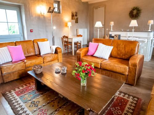 a living room with two couches and a coffee table at Getaway with Sauna in Falaën in Maredsous