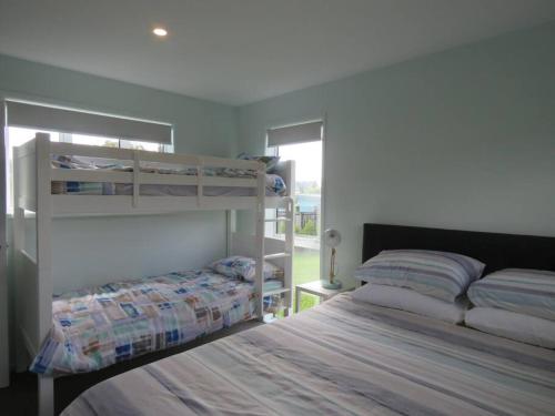 a bedroom with two bunk beds and a window at Sunny Sands in Coopers Beach