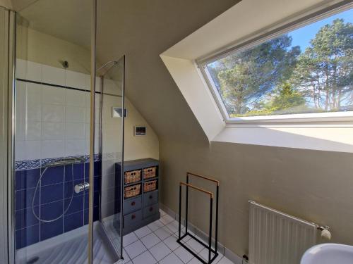 a bathroom with a shower and a window at Holiday Home in Paimpol near Beach in Paimpol
