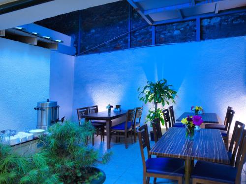 a dining room with tables and chairs and blue lighting at Monarch Hotel Istanbul in Istanbul