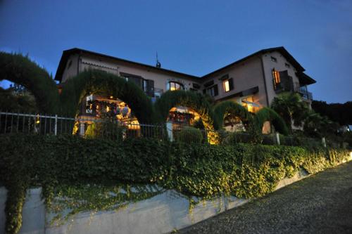 a large building with lights in front of it at Albergo Ristorante Conca Azzurra in Colico