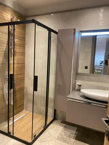 a bathroom with a sink and a glass shower at Luxury one bedroom in Diamond in the city in Accra