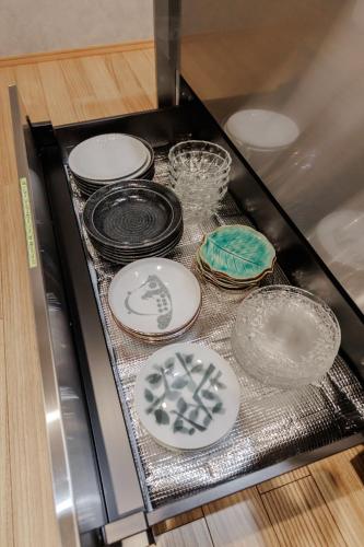 a bunch of plates and bowls on a stove at moku杢 つばき in Miyazu