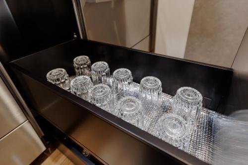 a bunch of clear glasses sitting on a shelf at moku杢 つばき in Miyazu
