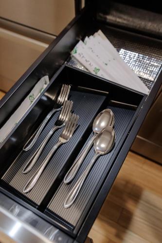 a tray with silver utensils on a table at moku杢 つばき in Miyazu