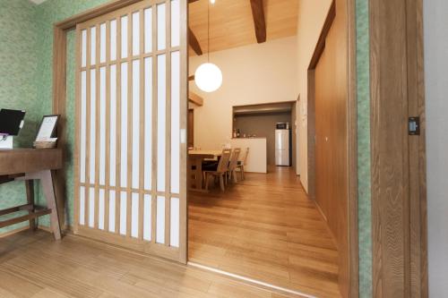 a hallway with a door leading to a dining room at moku杢 つばき in Miyazu