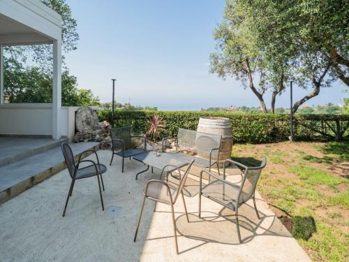 a group of chairs and a table on a patio at Apartment in Gasponi with Mountain Views in Gasponi