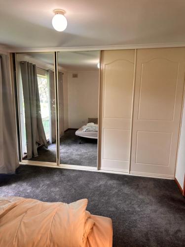 a bedroom with mirrors and a bed in a room at 333 chalkhill rd McLaren vale 5171 in McLaren Vale