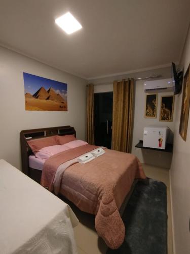 a hotel room with two beds and a television at Pousada Consulado in Brasília