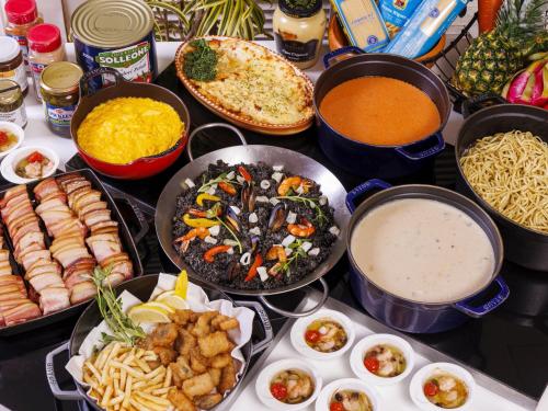 a table with many different dishes of food on it at Hotel Shigira Mirage Beach Front in Miyako Island