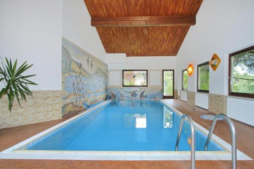 a pool in a building with a large swimming pool at Apartment in Latsch with Indoor Pool & Garden in Laces