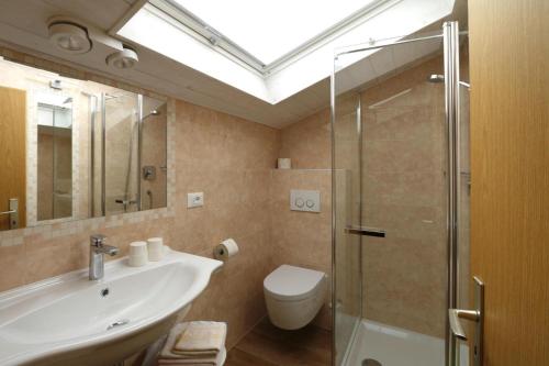 a bathroom with a toilet and a sink and a shower at Apartment in Latsch with Indoor Pool & Garden in Laces