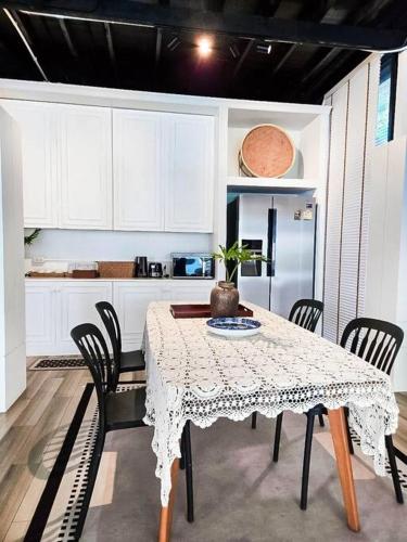 a kitchen with a table with chairs and a refrigerator at Siraburi boutique pool villa at Center of old town in Chiang Mai
