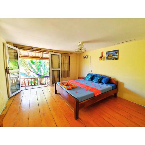 a bedroom with a bed and a large window at Mangrove Beach Bungalows in Koh Rong Sanloem