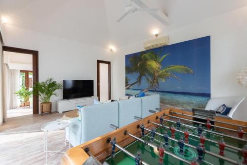 a living room with a ping pong table at Ban Suriya in Lipa Noi