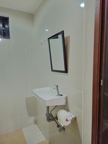 a bathroom with a sink and a mirror at Casa Celine Dumaguete in Dumaguete
