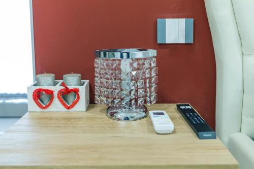 a table with a remote control and a vase on it at Terraforte Luxury Suite in Fisciano