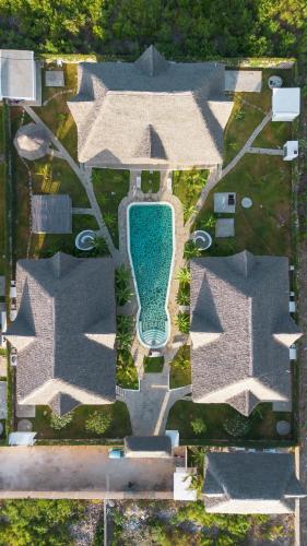 an aerial view of a house with a swimming pool at Cacuki Boutique House in Watamu