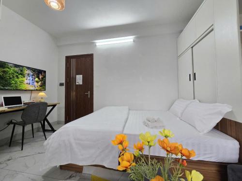a bedroom with a bed and a desk with a computer at The Chilling'N Homestay Ha Noi 89 in Hanoi