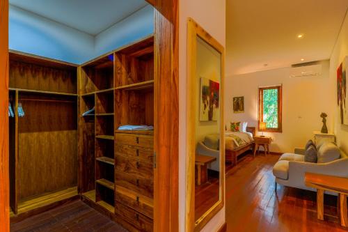 a living room with a bedroom and a bed at Paradise Garage Komodo Villa in Labuan Bajo