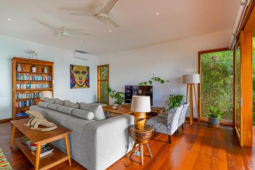 a living room with a couch and a table at Paradise Garage Komodo Villa in Labuan Bajo