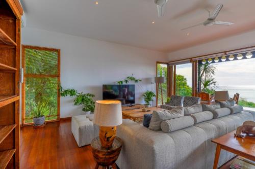 a living room with a large couch and a table at Paradise Garage Komodo Villa in Labuan Bajo
