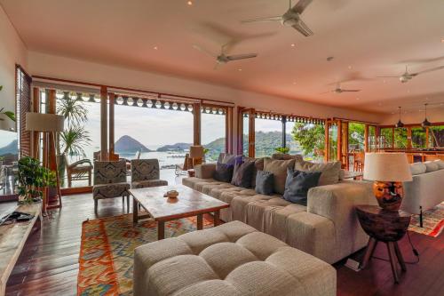 a living room with a couch and a table at Paradise Garage Komodo Villa in Labuan Bajo