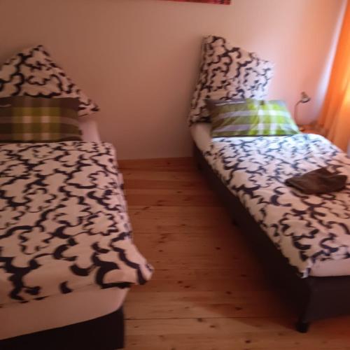 a bedroom with a bed and a couch with pillows at Neu Maisonette Haus jedes Zimmer mit eigenem Bad , Schlafen wie im Hotel mit Einbauküche in Eschweiler