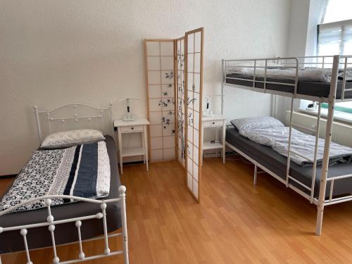 a room with two bunk beds and a desk at Terrace Apartment Saxony in Eilenburg