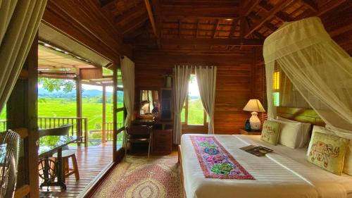 a bedroom with a bed and a desk in a room at Nan Seasons Boutique Resort in Nan