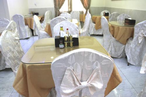 a room with chairs and a table with bottles of champagne at Al Ahrar Hotel in Dubai