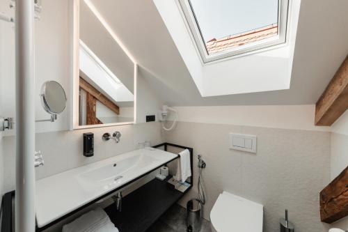 a bathroom with a sink and a skylight at Hotel Clemar in Znojmo
