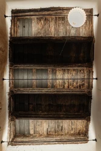 a wooden wall with a chandelier on top of it at Hotel Clemar in Znojmo