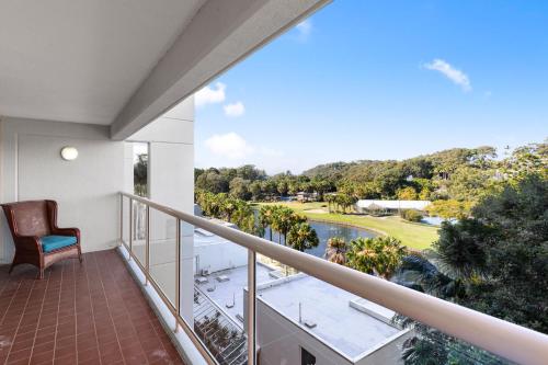 a balcony with a view of a golf course at Charlesworth Bay Beach Resort in Coffs Harbour
