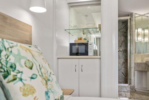 a living room with a microwave on a shelf at Charlesworth Bay Beach Resort in Coffs Harbour