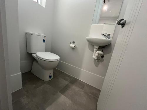 a bathroom with a toilet and a sink at 1 95 Esplanade, Semaphore in Semaphore