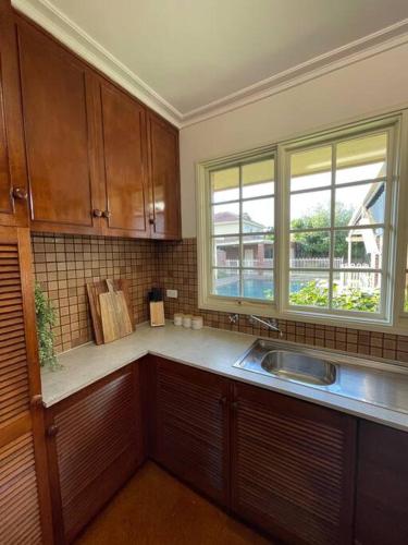 a kitchen with a sink and a window at Hampton Spacious House & Pool in Melbourne