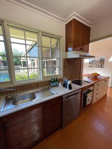 a kitchen with a sink and a counter top at Hampton Spacious House & Pool in Melbourne
