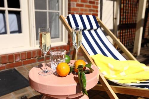 a table with two glasses of champagne and fruit on it at Hampton Spacious House & Pool in Melbourne