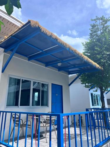 a blue pergola over a porch of a house at Three Trees Samui Resort - Sarocha Villa in Lamai