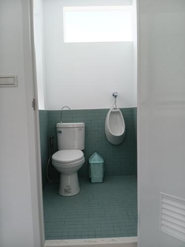 a bathroom with a white toilet and a sink at 高一 33 班 Homestay 1982 in Chenggong