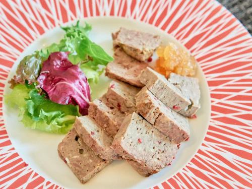 a plate of food on a red and white plate at Tabist Kaihorow Otaru in Otaru