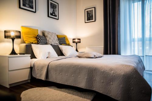 a bedroom with a large bed and a window at Apartment Extra Home in Kielce